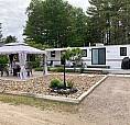 Park Model Trailer On Landscaped Lot
