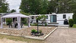 Park Model Trailer On Landscaped Lot
